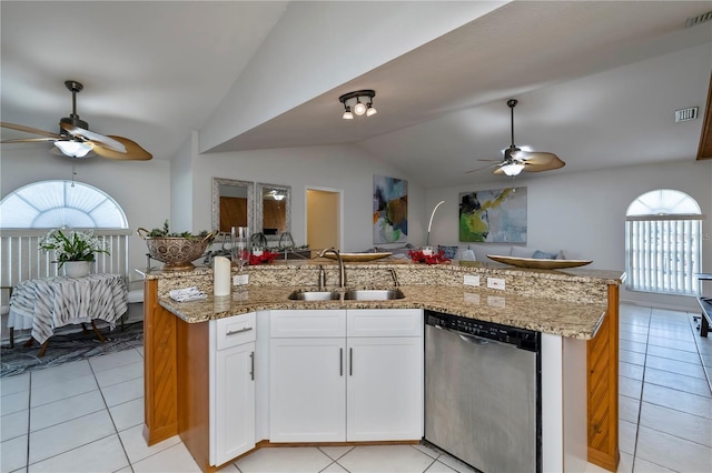 kitchen featuring dishwasher, white cabinets, sink, vaulted ceiling, and light tile patterned floors