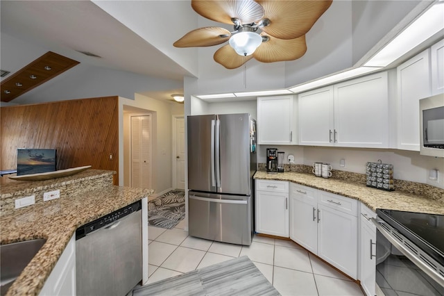 kitchen with white cabinets, light tile patterned floors, and appliances with stainless steel finishes