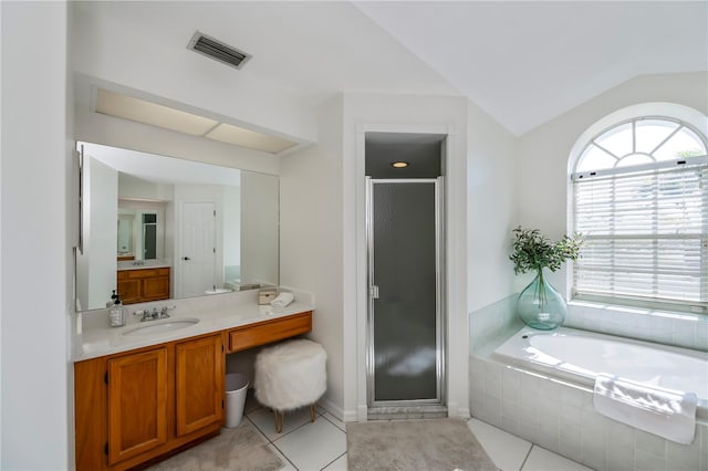 bathroom with tile patterned floors, vanity, separate shower and tub, and vaulted ceiling