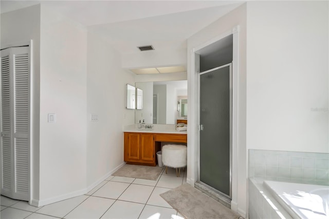 bathroom featuring tile patterned flooring, vanity, and separate shower and tub