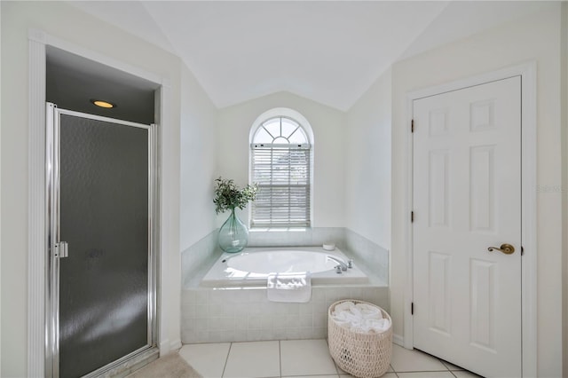 bathroom with plus walk in shower, vaulted ceiling, and tile patterned floors