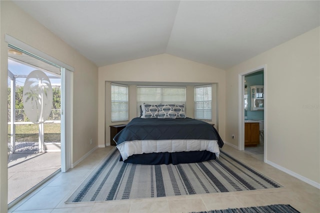 tiled bedroom with access to exterior, lofted ceiling, and connected bathroom