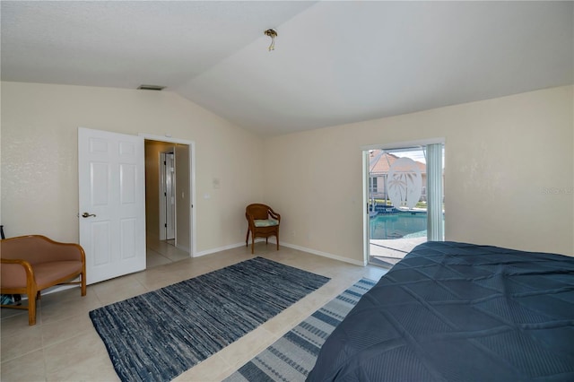 bedroom featuring access to exterior, lofted ceiling, and light tile patterned floors