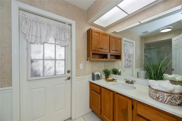 bathroom featuring tile patterned flooring, vanity, toilet, and a shower with curtain