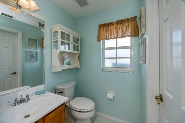 bathroom with tile patterned flooring, vanity, and toilet