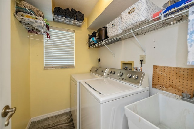 laundry area with washing machine and clothes dryer and sink