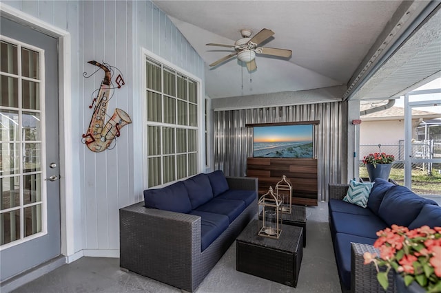 sunroom / solarium with ceiling fan and vaulted ceiling