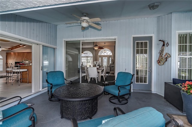 view of patio / terrace featuring ceiling fan and a bar