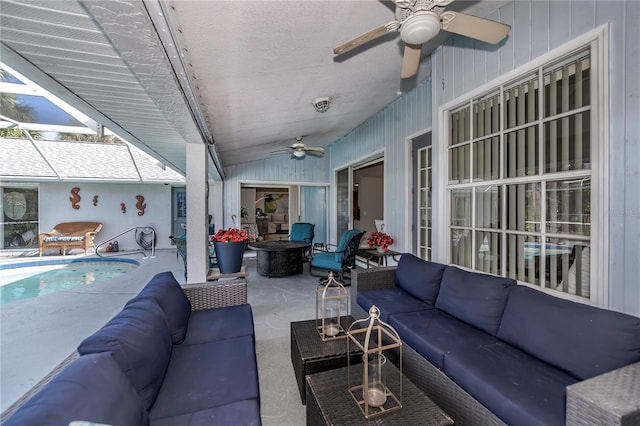 view of patio / terrace featuring an outdoor living space with a fire pit and ceiling fan