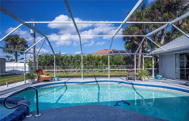 view of swimming pool with glass enclosure and a patio