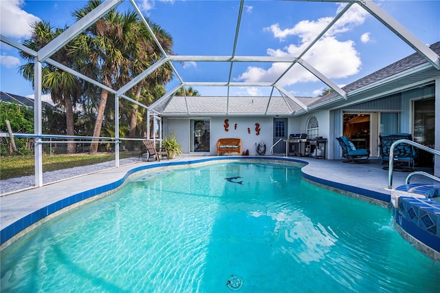 view of pool featuring a lanai, a patio area, pool water feature, and grilling area