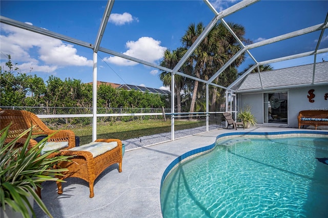 view of pool featuring a patio and glass enclosure