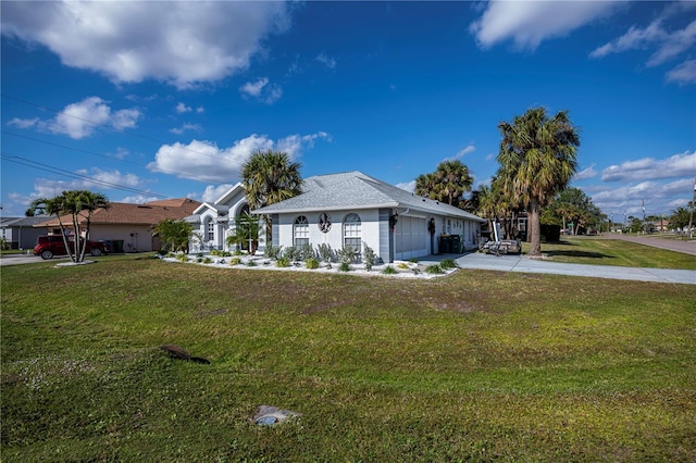 single story home featuring a garage and a front yard