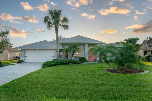 view of front of home featuring a lawn and a garage