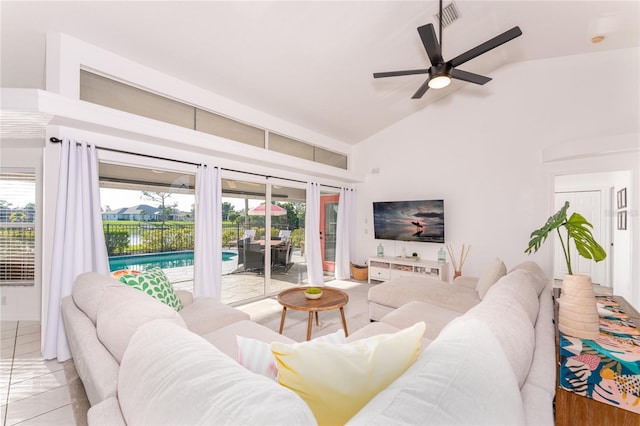 living room featuring ceiling fan, lofted ceiling, and light tile patterned flooring