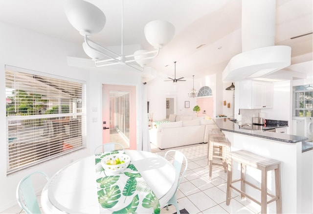 dining space featuring ceiling fan and light tile patterned floors