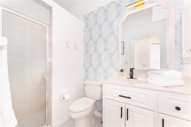 bathroom with vanity, toilet, and a shower with shower door