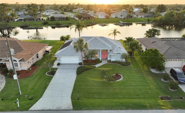 aerial view at dusk with a water view