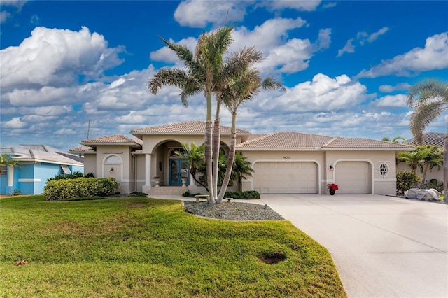 mediterranean / spanish house with a garage and a front yard