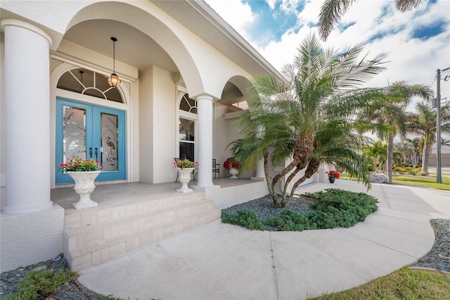 entrance to property with french doors and a porch