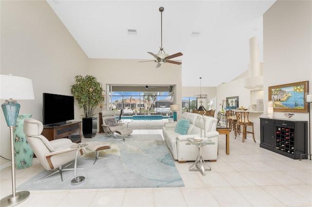 living room with light tile patterned floors, high vaulted ceiling, and ceiling fan