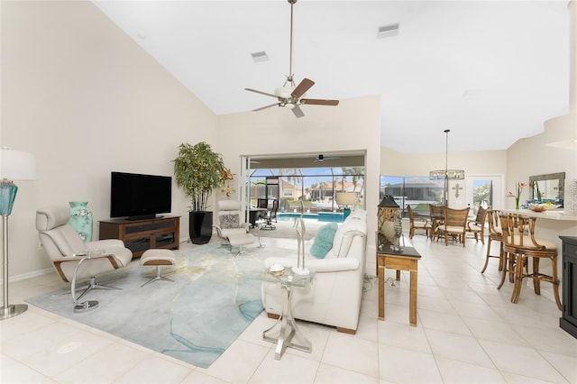 tiled living room with high vaulted ceiling and ceiling fan