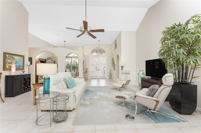 living room featuring ceiling fan, light tile patterned flooring, vaulted ceiling, and french doors