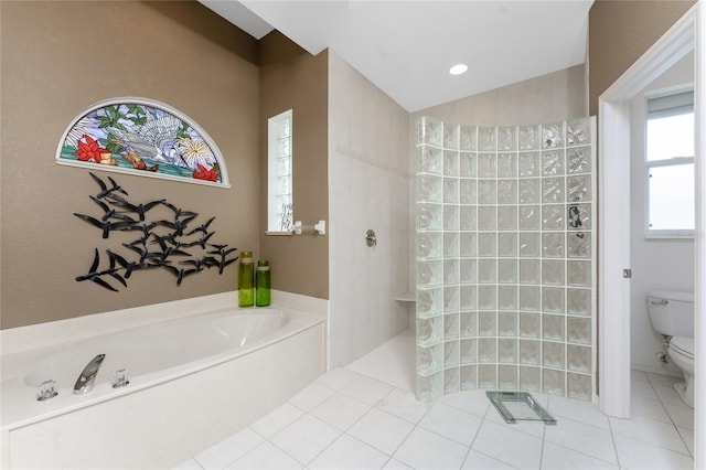 bathroom featuring tile patterned flooring, toilet, and independent shower and bath