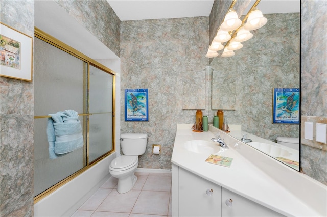 full bathroom featuring toilet, tile patterned flooring, vanity, and combined bath / shower with glass door