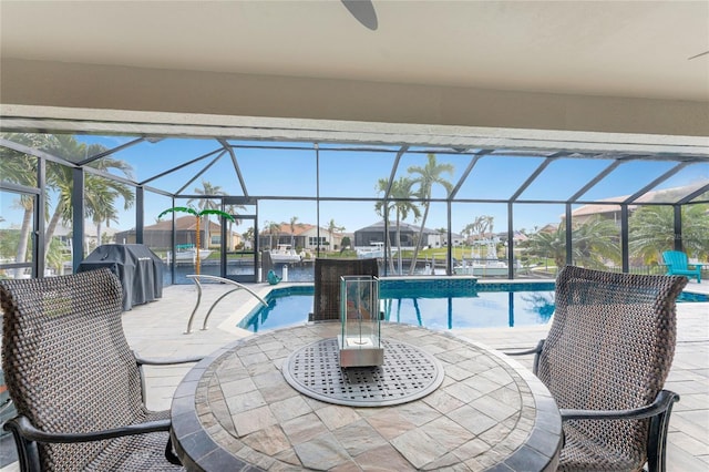 view of swimming pool featuring glass enclosure, a grill, and a patio