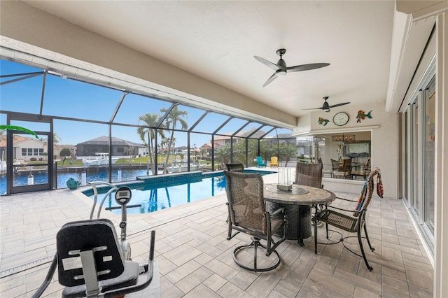 view of pool with a water view, a patio area, and a lanai