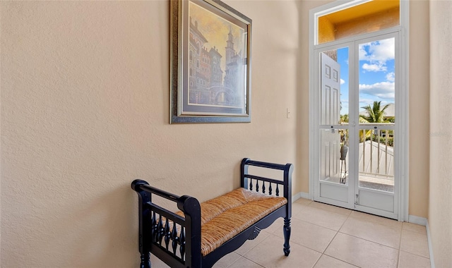 doorway with light tile patterned floors