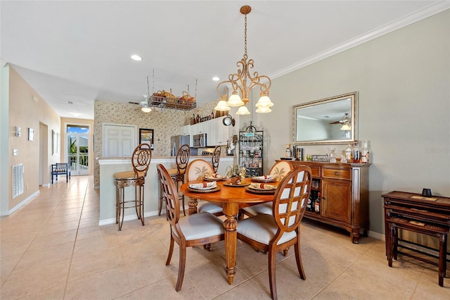 tiled dining space with crown molding and ceiling fan