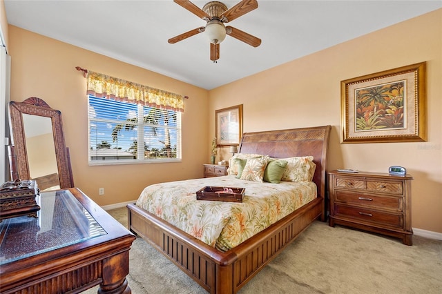 bedroom with ceiling fan and light carpet