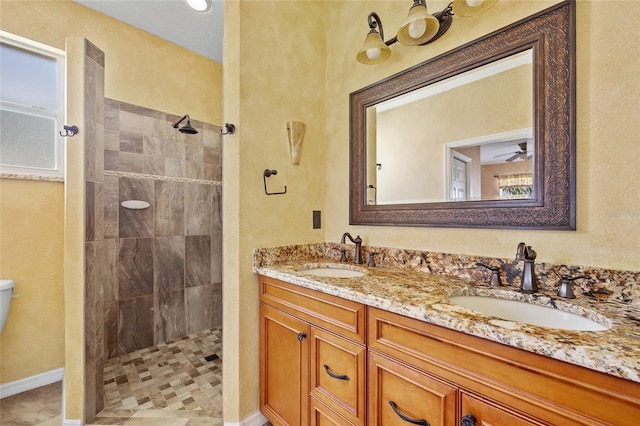 bathroom with vanity and a tile shower