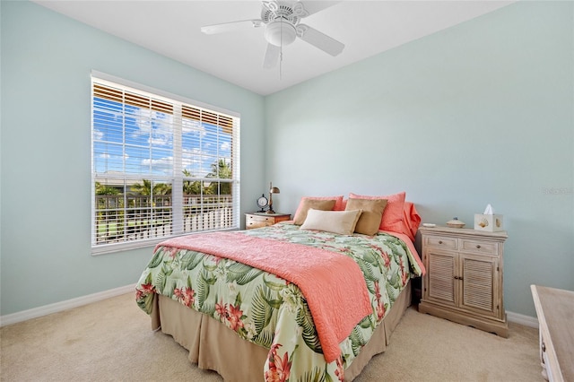 bedroom featuring light colored carpet and ceiling fan