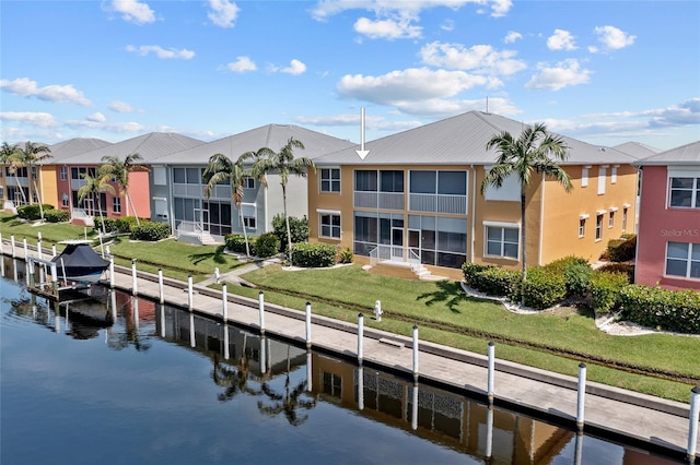 dock area featuring a yard and a water view