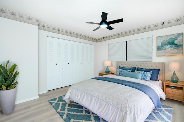 bedroom featuring ceiling fan, light hardwood / wood-style flooring, and a closet