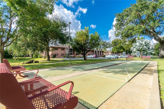 view of property's community featuring a yard