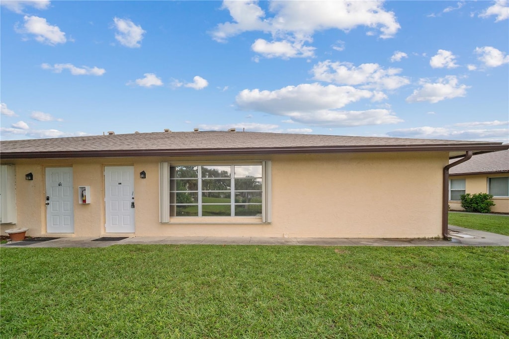 rear view of property with a yard