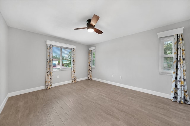 unfurnished room with ceiling fan and light hardwood / wood-style floors