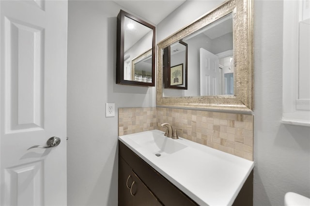 bathroom with vanity and tasteful backsplash