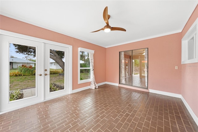 unfurnished room featuring french doors, ceiling fan, and crown molding