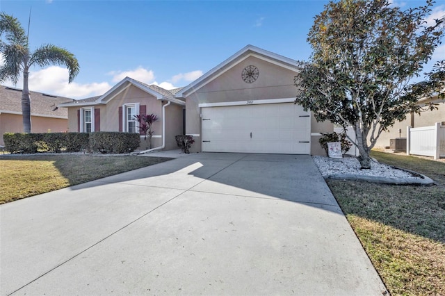 single story home featuring a garage and a front lawn