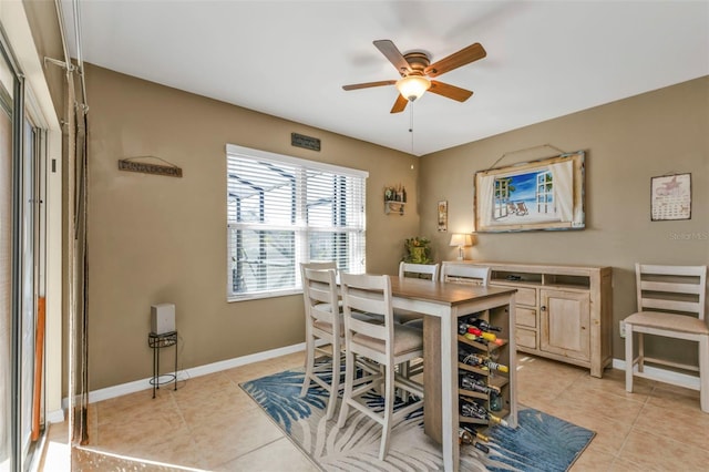 tiled dining space with ceiling fan