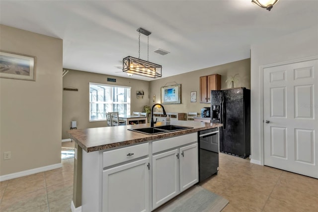 kitchen featuring pendant lighting, black appliances, sink, white cabinetry, and an island with sink