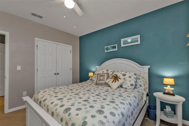 carpeted bedroom featuring ceiling fan and a closet