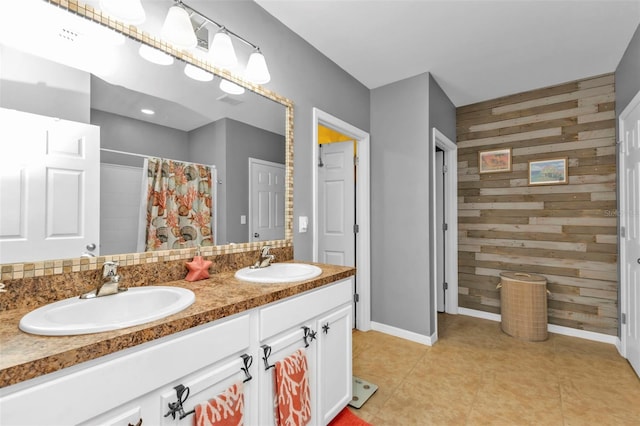 bathroom featuring walk in shower, wood walls, and vanity