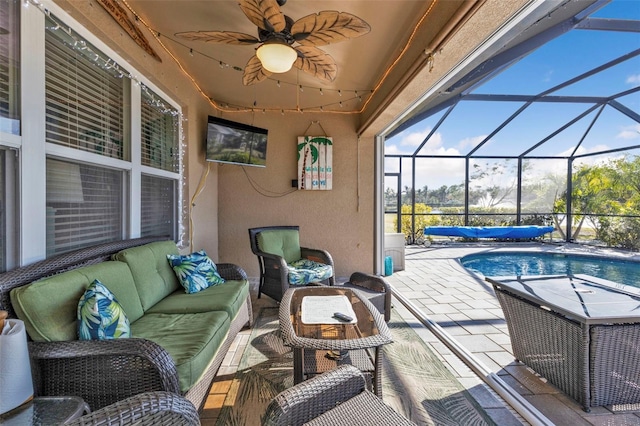 view of patio / terrace featuring glass enclosure, an outdoor living space, and ceiling fan