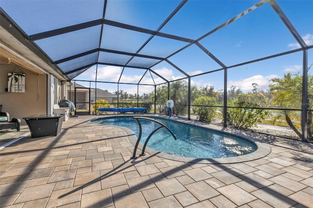 view of swimming pool featuring glass enclosure and a patio